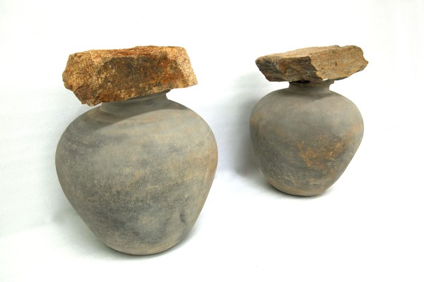 백제 왕릉급 무덤이 모여 있는 충남 부여 왕릉원의 한 고분 입구에서 편평한 깬 돌을 뚜껑처럼 얹은 토기 2점이 나왔다. 사진/ 뉴시스 제공