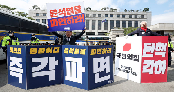 윤석열 대통령에 대한 탄핵심판 선고가 지연되고 있는 28일 오전 서울 종로구 헌법재판소 앞에서 안태준(왼쪽) 더불어민주당 의원이 윤 대통령 파면을, 하종대 국민의힘 부천시병 당협위원장이 탄핵 각하를 각각 촉구하는 1인시위를 하고 있다.   사진/뉴시스