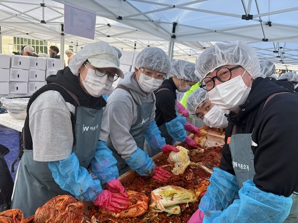 JW 임직원들이 지난 1일 과천시민회관 시계탑 광장에서 열린 '2025년 모두가 나누는 김장축제'에서 김장을 담그고 있다. / 사진 = JW중외제약 제공
